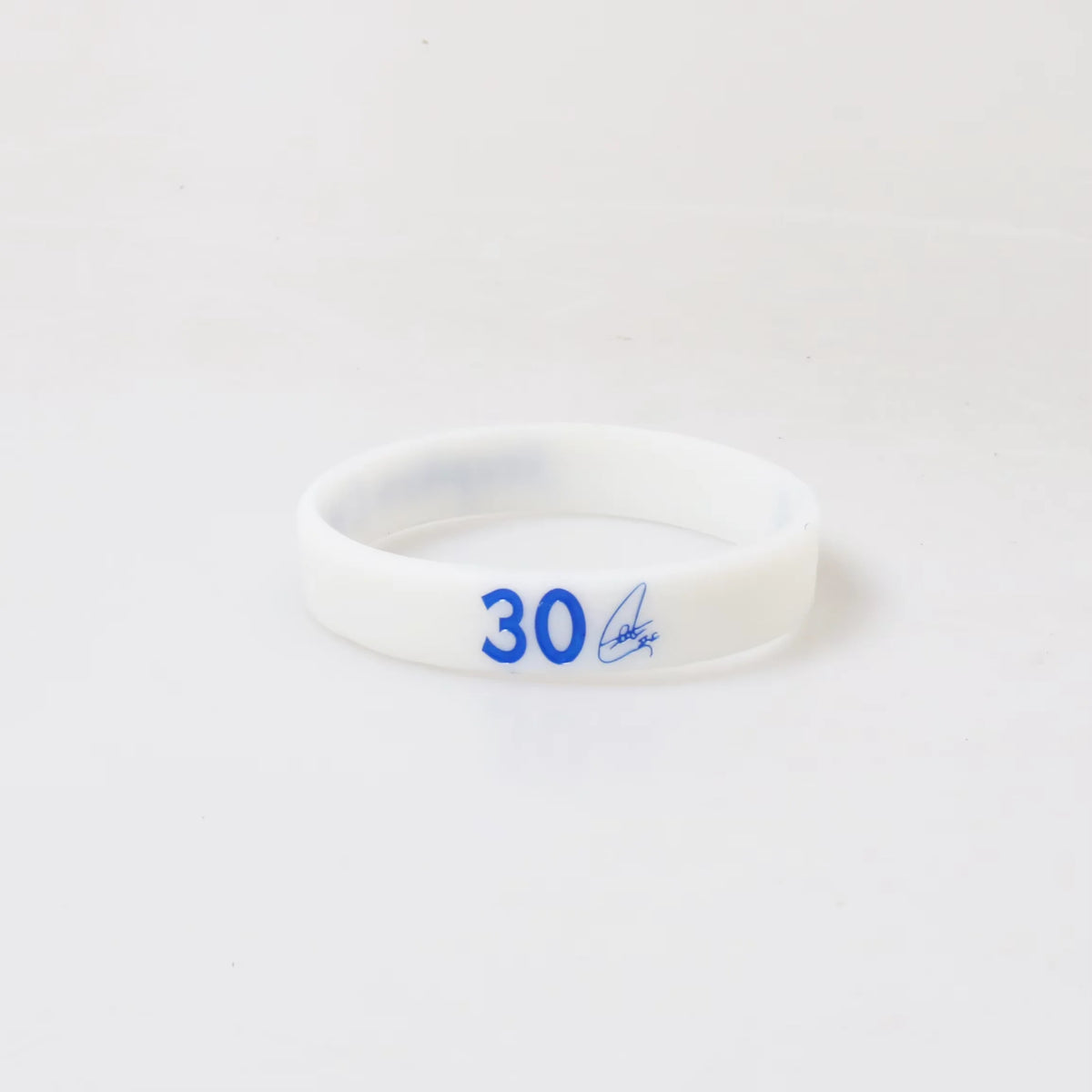 A white silicone wristband with the number 30 printed on it.