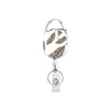 A silver retractable ID badge reel keychain featuring a leaf design.