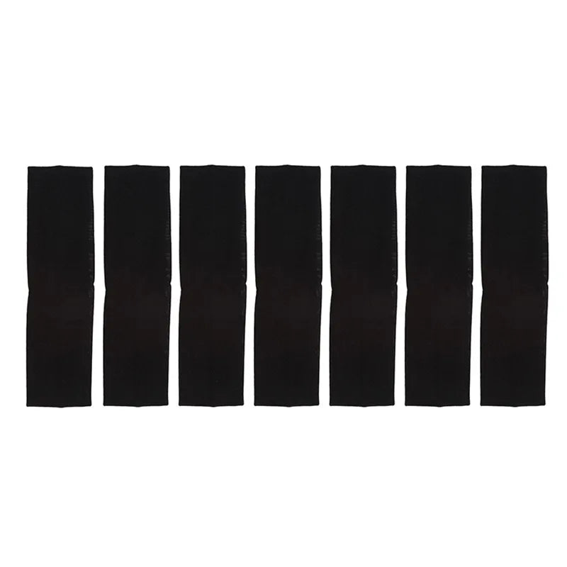A set of solid black elastic hair bands arranged in a row.