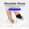 A person wearing lightweight, white and gray wearable shoes for comfortable walking.