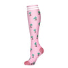 Pink compression socks with a tropical tree pattern
