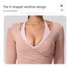A model wearing a V-shaped neckline long sleeve top in a dusty rose color.