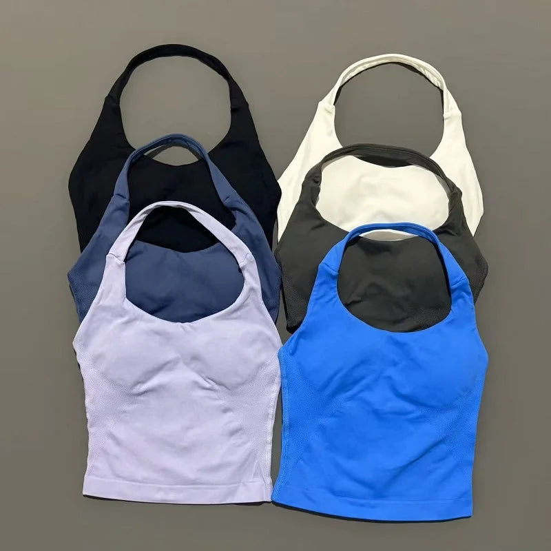 A collection of five seamless performance yoga and gym tank tops in black, gray, purple, blue, and white.
