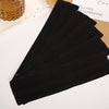 A stack of five black elastic hairbands for fitness and yoga placed on a white surface.