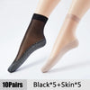 A pair of black and skin-toned ultra-thin breathable ankle socks shown on a model's leg.