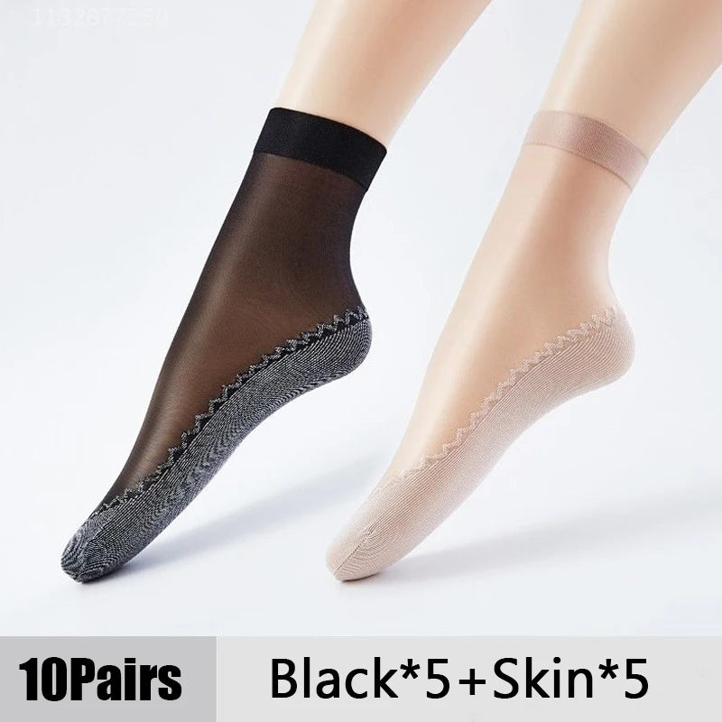 A pair of black and skin-toned ultra-thin breathable ankle socks shown on a model's leg.