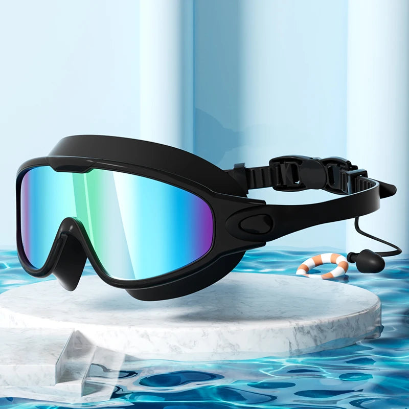 Black anti-fog UV protection swimming goggles resting on a white marble surface with blue water background