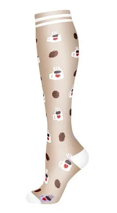 A close-up view of beige compression socks with small heart patterns and white tips.