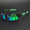 Wraparound sports sunglasses with a black frame and bright green accents resting on a dark surface.