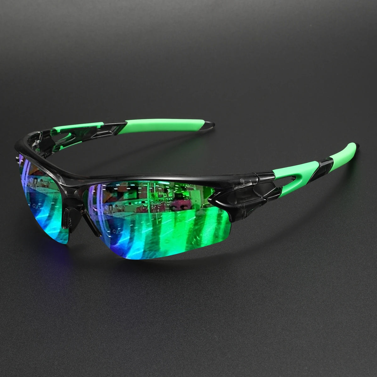 Wraparound sports sunglasses with a black frame and bright green accents resting on a dark surface.