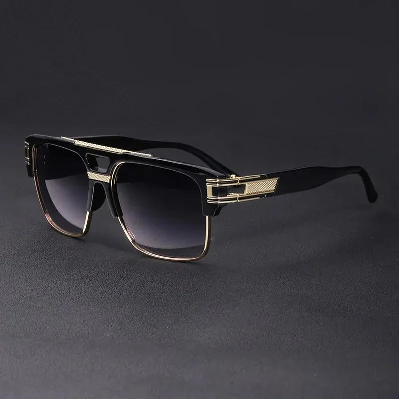 A pair of classic retro square sunglasses with black frames and gold accents resting on a dark surface.