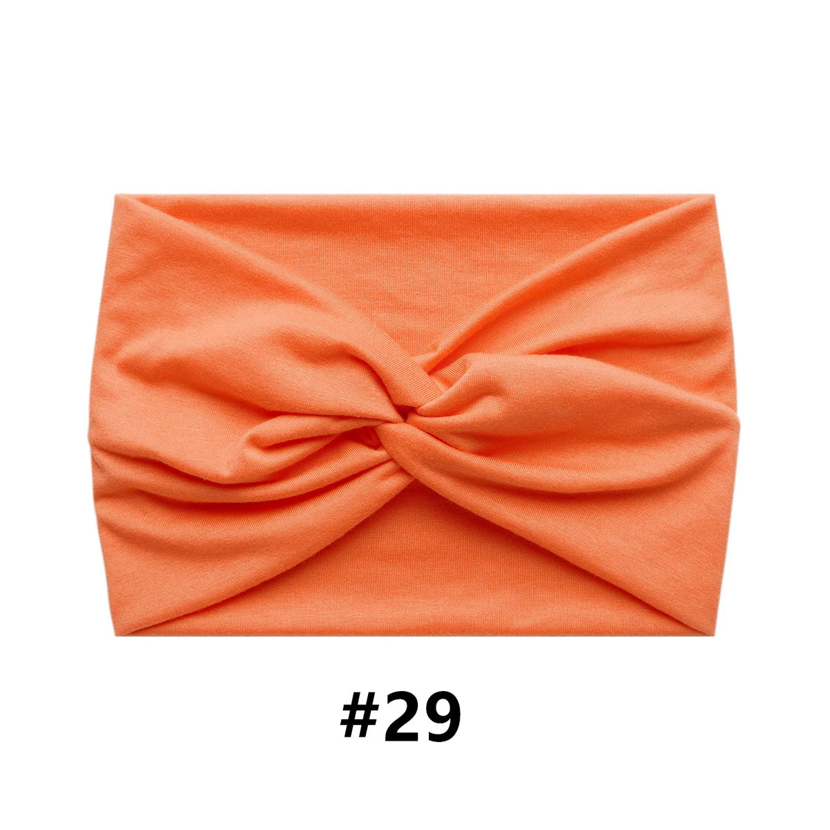 A folded orange boho wide turban headband for women, labeled #29.