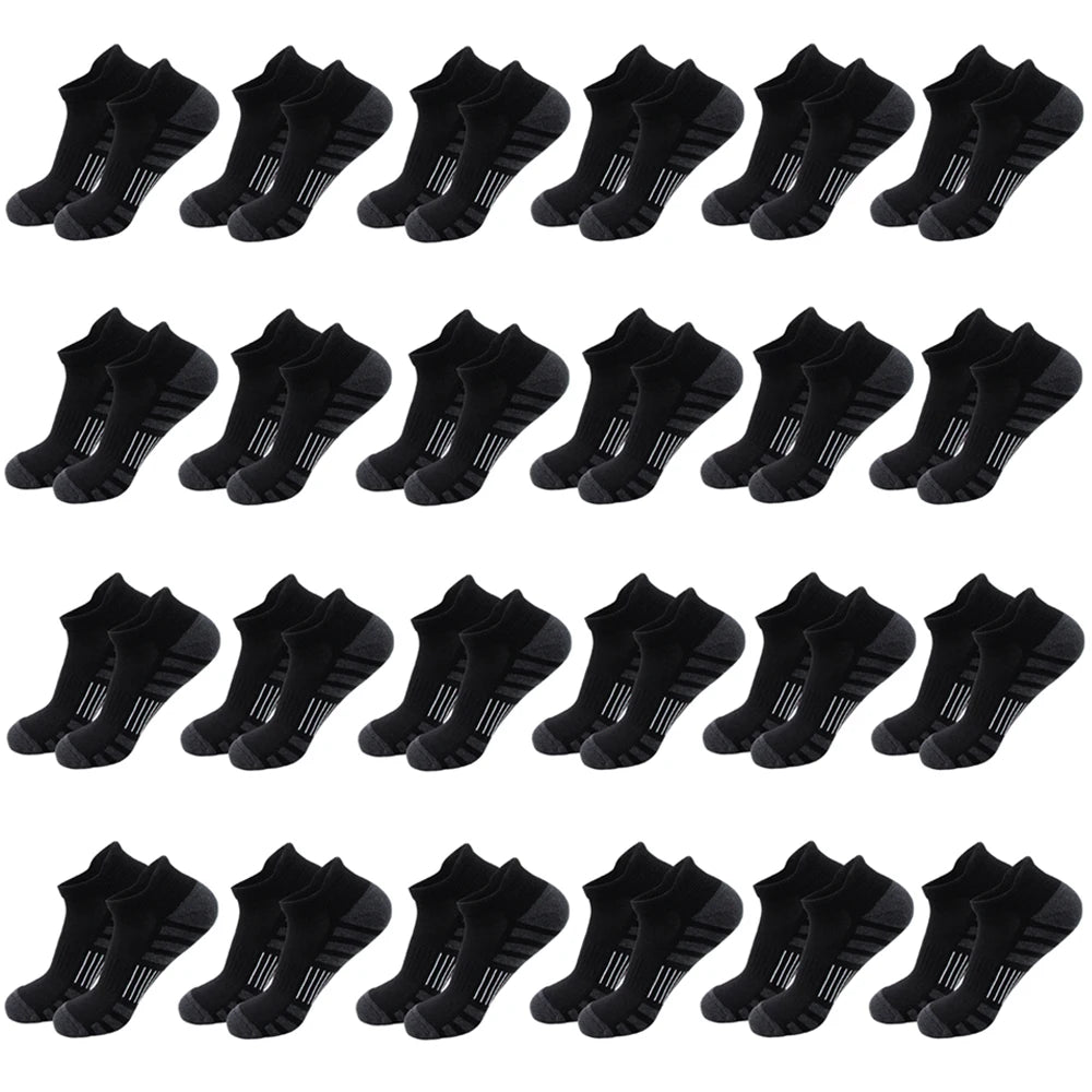 A row of black ankle athletic running socks for men and women displayed flat.