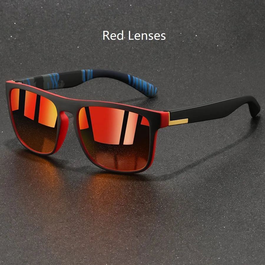 A pair of black sunglasses with red lenses and a dark frame resting on a dark surface.
