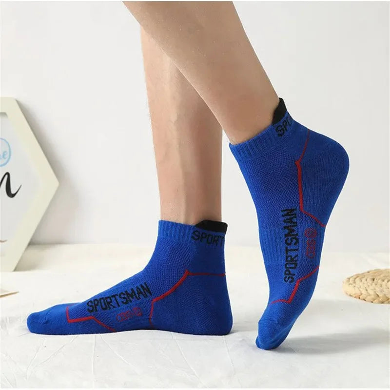 A pair of blue performance socks with red stitching and the word SPORTSMAN visible on the foot.