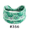 A green and white patterned boho knotted cotton headband for yoga or workout.