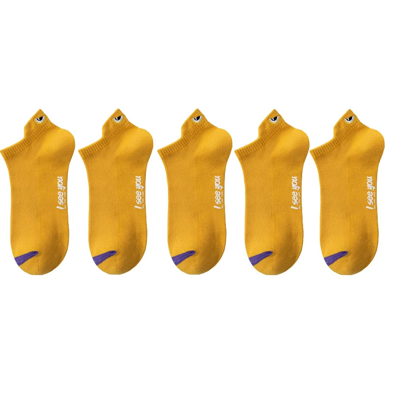 Five pairs of yellow ankle boat socks with purple accents displayed side by side.