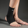 A black Vaosi ankle support brace worn on a person's lower leg and foot.