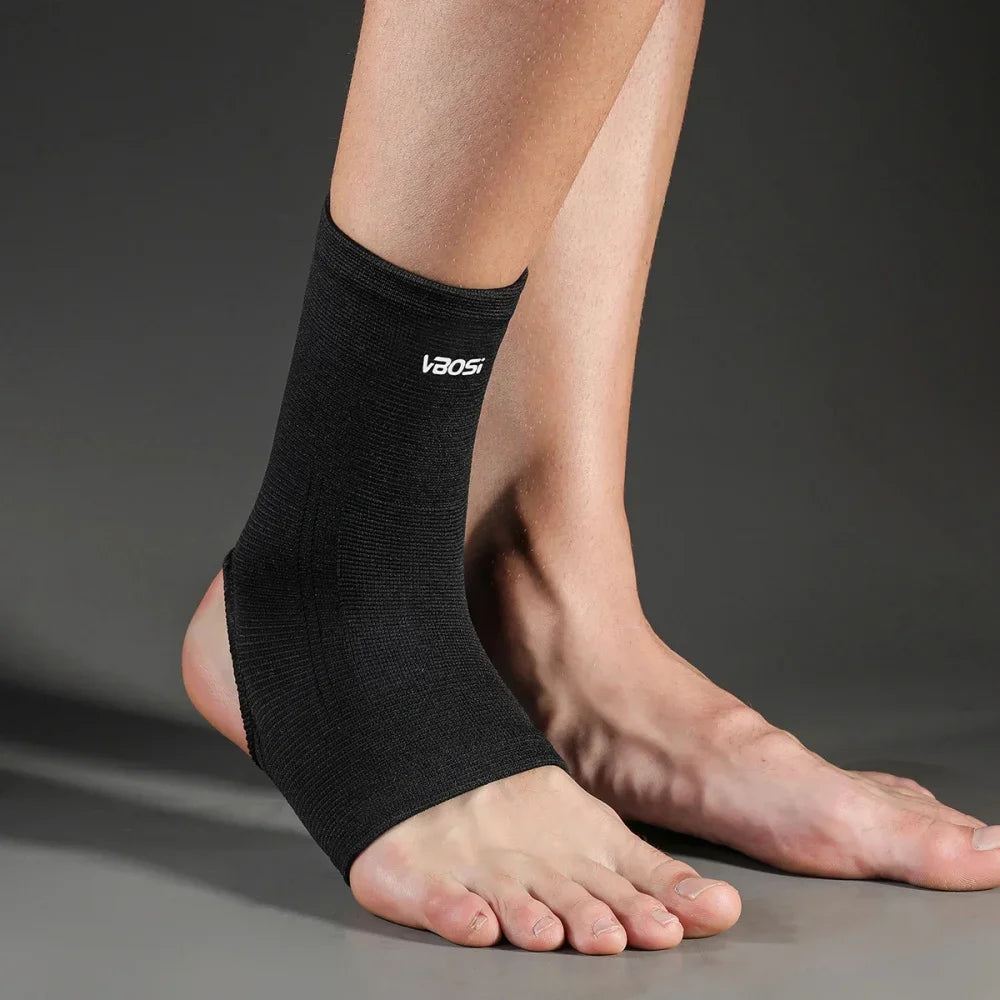 A black Vaosi ankle support brace worn on a person's lower leg and foot.