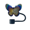 A silicone butterfly straw cover for tumblers with iridescent purple and gold coloring.