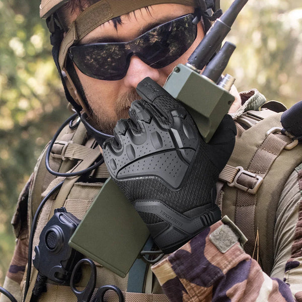 A person wearing tactical gloves and sunglasses is visible in an outdoor setting.