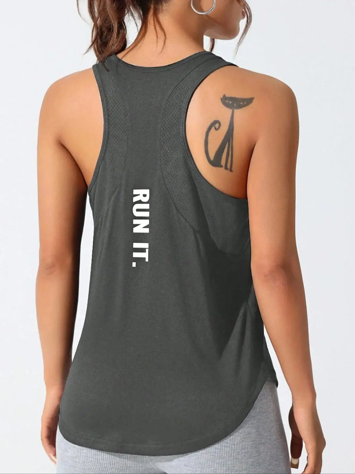 A woman wearing a dark gray running vest with the text RUN IT on the back.