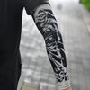 Black leg featuring a white skull and bone tattoo sleeve on the lower leg.