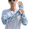 Person in white shirt with blue patterned UV protection loose sleeves on the right arm.