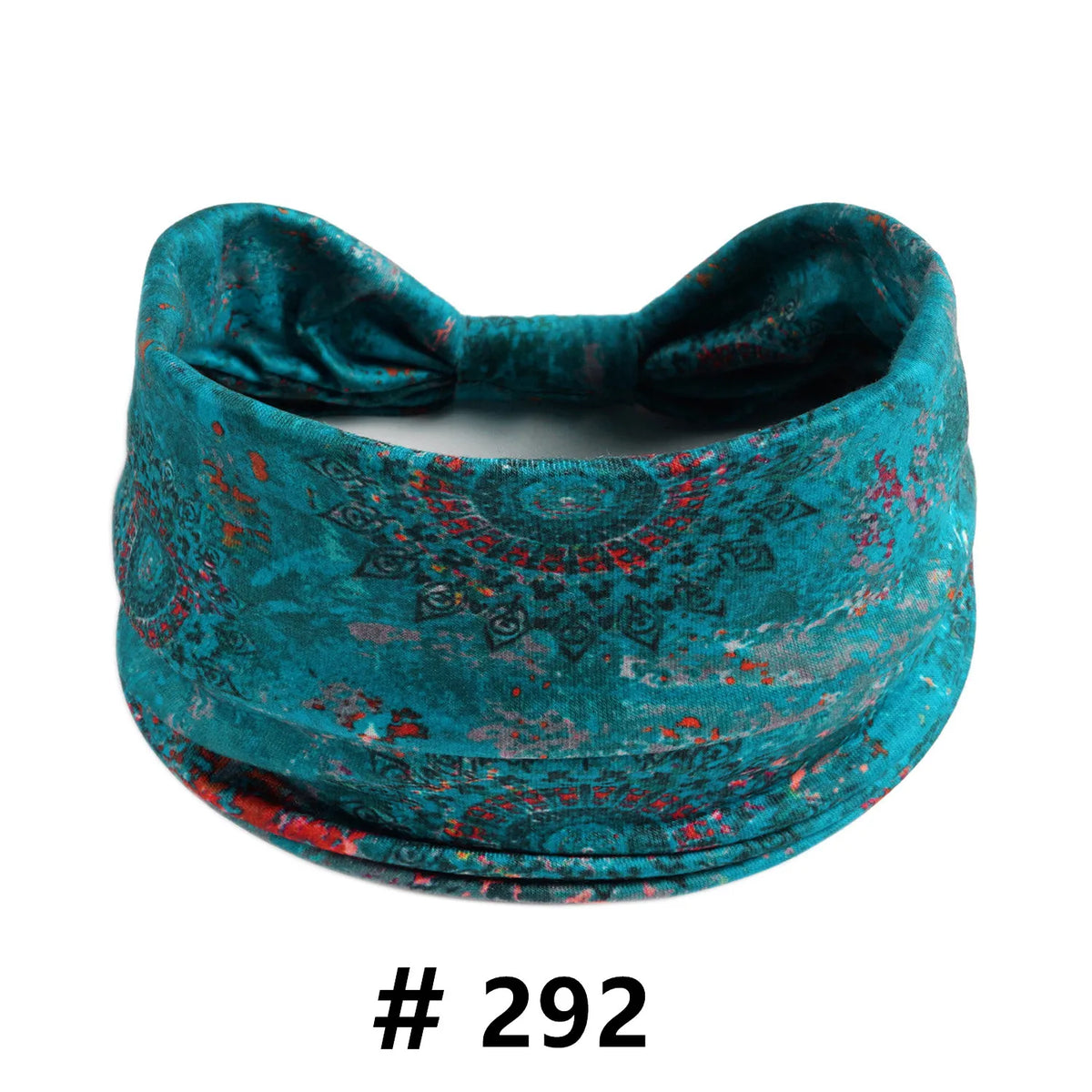 A teal boho cotton turban headband with a floral pattern, shown flat.