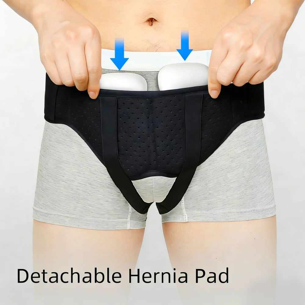 A black hernia belt is shown being worn over light gray shorts, with white compression pads visible on the abdomen.