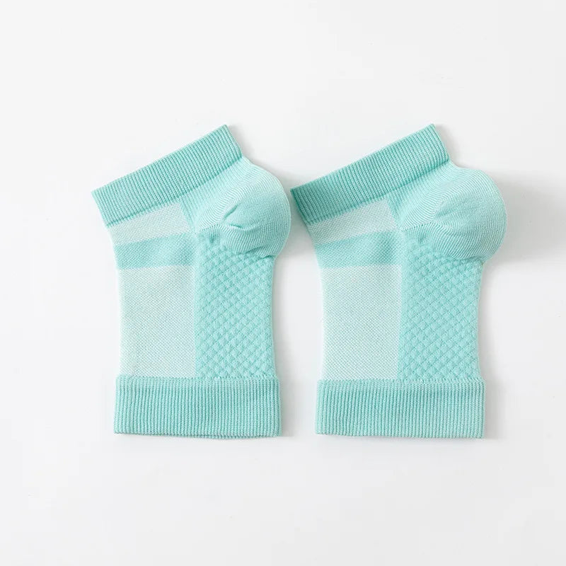 A pair of light blue therapeutic compression socks for foot and ankle pain relief.