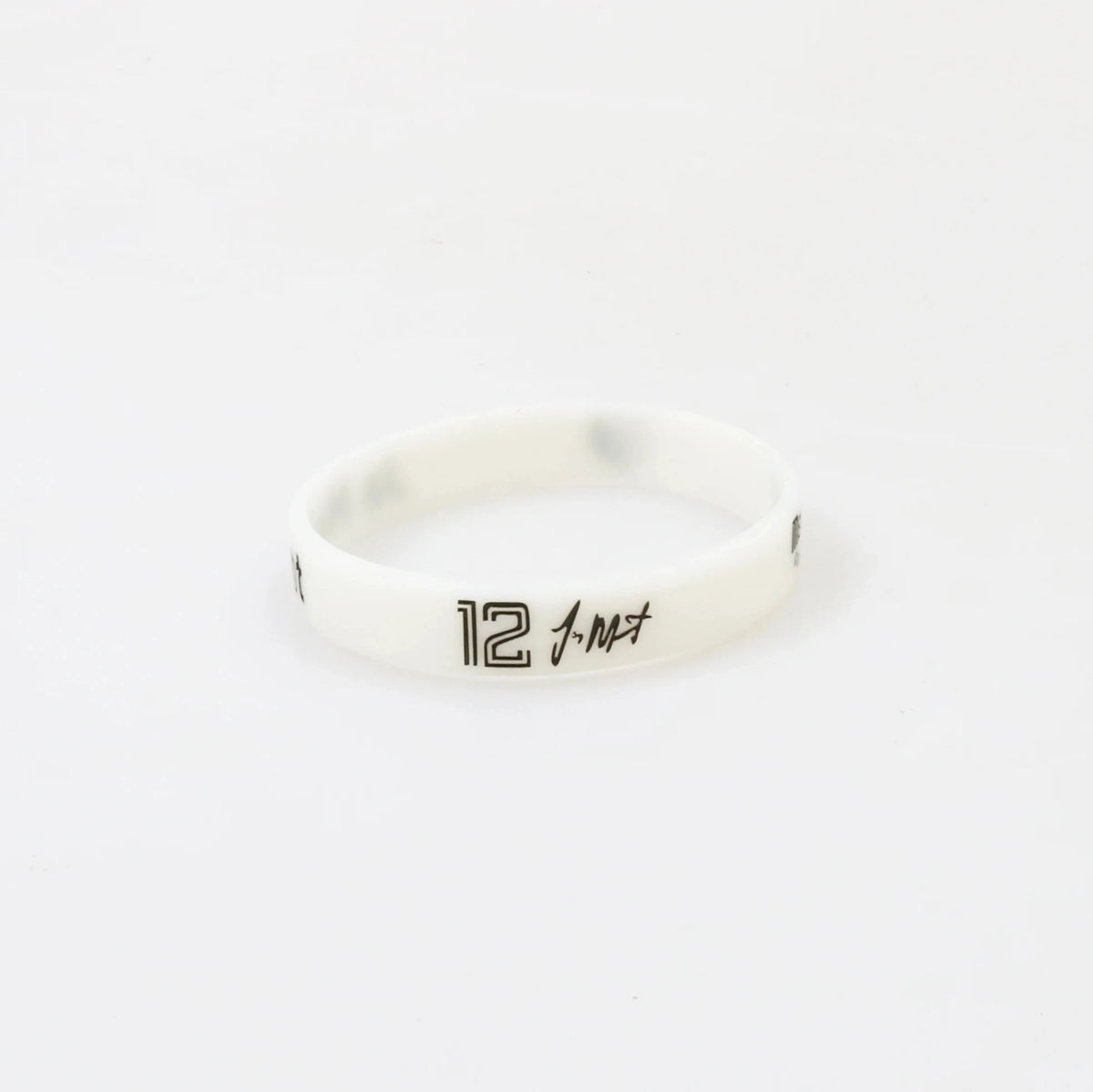 A white silicone wristband with the number 12 engraved on it.