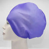 A purple silicone swim cap is shown on a mannequin head.