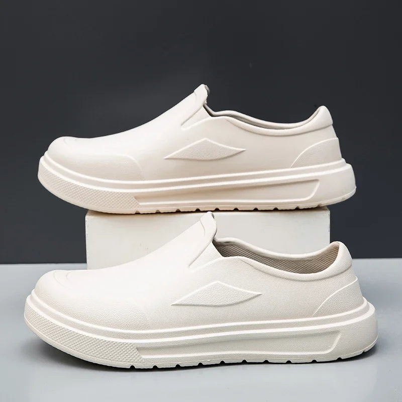A pair of white men's anti-slip oil-resistant kitchen clogs shown in a studio setting.