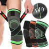 Adjustable sports knee pads in black, gray, and orange colors shown on a leg.