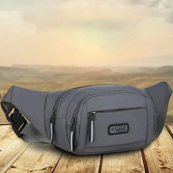 A gray durable nylon waist bag for men lying on a wooden surface.