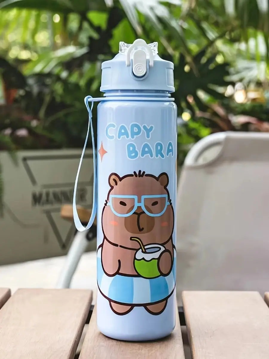 A light blue cartoon drinking water bottle featuring a bear wearing glasses and holding a cup, set against a blurred green ba