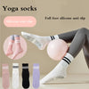 A collection of silicone anti-slip yoga socks in various colors including pink, white, black, and purple shown on a person's 
