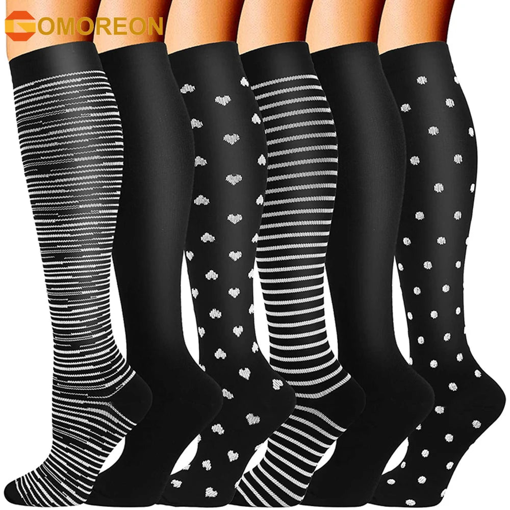 A set of black compression socks with various striped and patterned designs shown on legs.