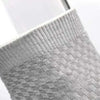 Close-up of light gray bamboo fibre anti-odor socks with a textured knit pattern.