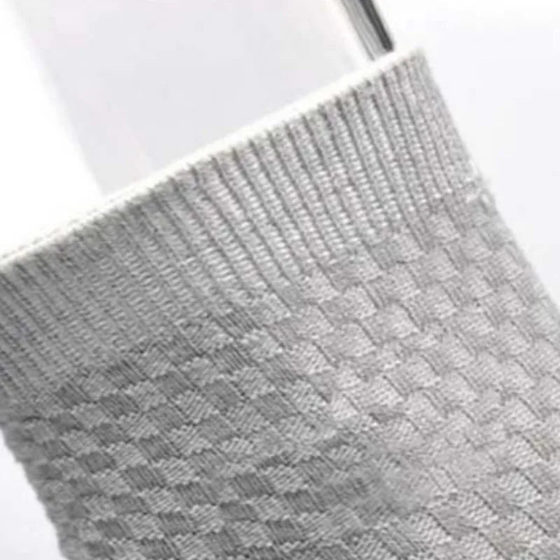 Close-up of light gray bamboo fibre anti-odor socks with a textured knit pattern.