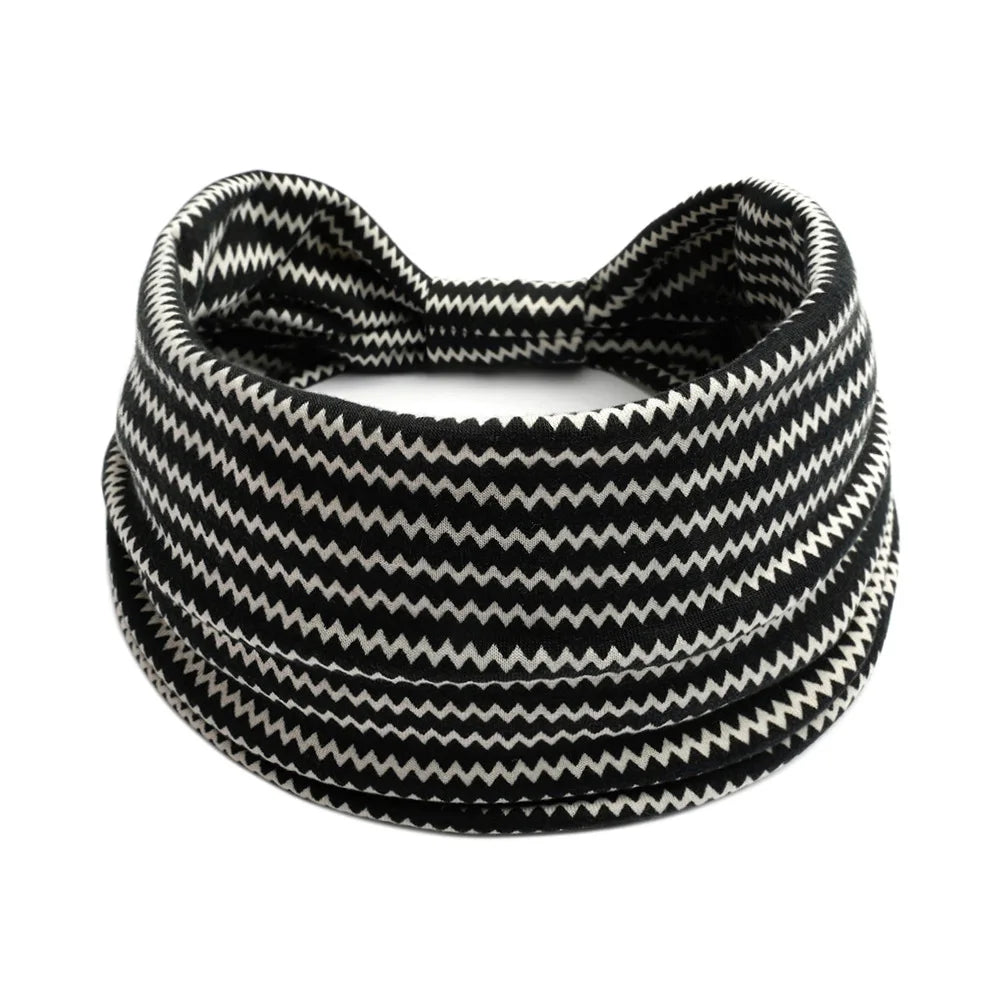 Black and white patterned stretch headbands rolled into a thick band