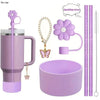 A set of reusable accessories for a tumbler, including a purple tumbler, a sparkling straw, a flower charm, and a purple cup.