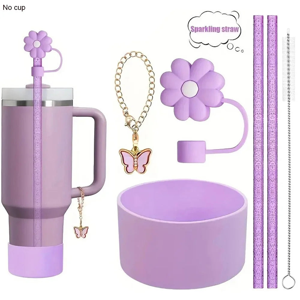 A set of reusable accessories for a tumbler, including a purple tumbler, a sparkling straw, a flower charm, and a purple cup.