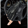 A close-up view of black PU leather fingerless fitness gloves resting on a car steering wheel.