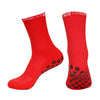 A pair of red performance sports gripping socks shown against a white background.