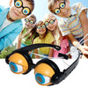 A pair of black novelty glasses with orange frames and blue lenses is shown in a product photo.