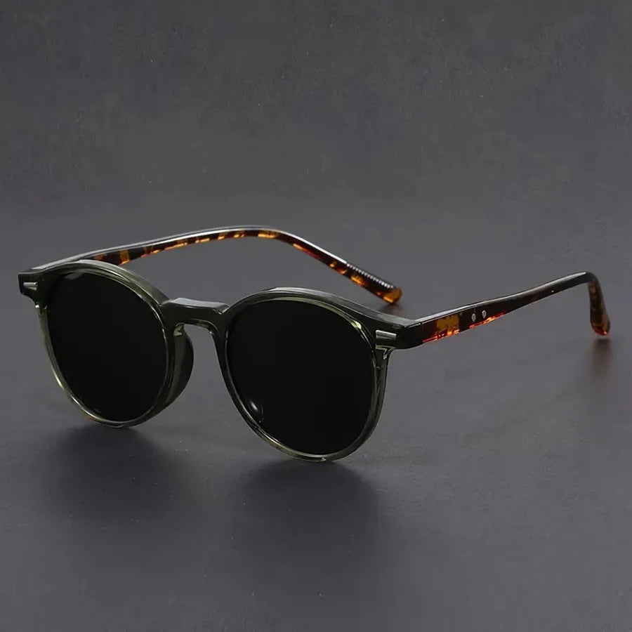 A pair of dark brown tinted retro round sunglasses with tortoiseshell frames.