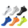 A pack of five athletic socks in various colors including white, gray, black, blue, orange, and neon yellow.