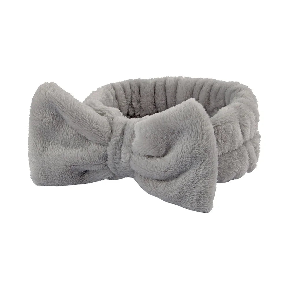 A gray microfiber spa headband and wristband set with a soft, fuzzy texture.